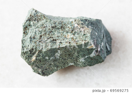 rough Tinguaite rock on white marble 69569275