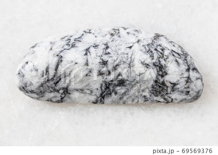 tumbled Magnesite rock on white marble 69569376