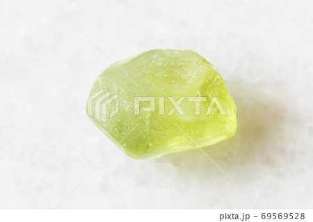 raw Olivine (Peridot, Chrysolite) crystal on white raw Olivine (Peridot, Chrysolite) crystal on white 69569528