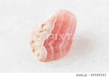 tumbled Rhodochrosite rock on white marble 69569565