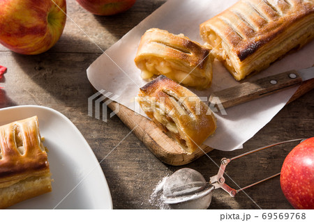 Traditional homemade apple strudel on wooden table Traditional homemade apple strudel on wooden table 69569768