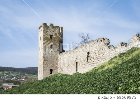Medieval wall and tower of Genoese fortress in the city of Feodosia on the Crimean Peninsula, built by colonists from Genoa in the 14th century 69569975