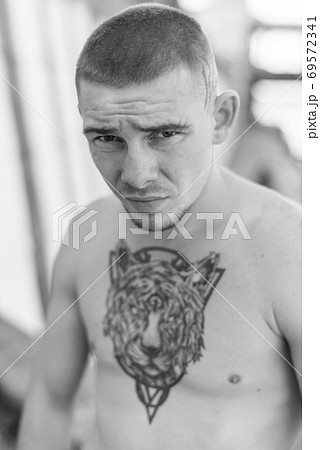 Male bully with a naked torso. Black and white photo Male bully with a naked torso. Black and white photo 69572341