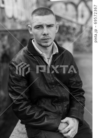 Bully criminal in black leather jacket. Black and white photo 69572367