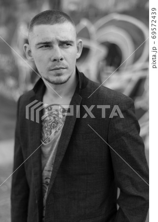 Portrait of a bully man in a jacket. Black and white photo Portrait of a bully man in a jacket. Black and white photo 69572439