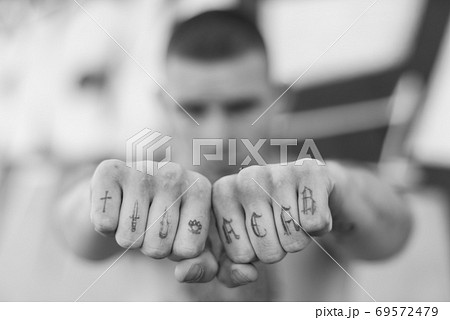 ACAB tattoo on the arm of a bully man. Black and white photo ACAB tattoo on the arm of a bully man. Black and white photo 69572479