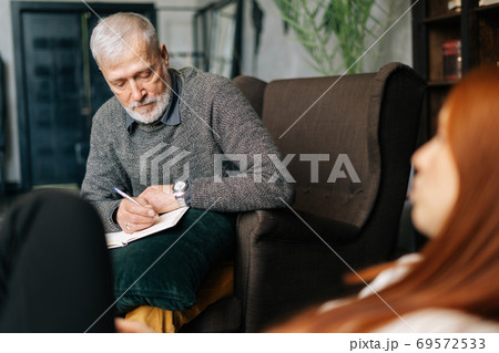 Bearded mature man psychologist with gray-hair is supporting and consoling depressed patient Bearded mature man psychologist with gray-hair is supporting and consoling depressed patient 69572533