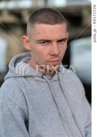 A bully guy in a light sports jacket with a hood A bully guy in a light sports jacket with a hood 69572538