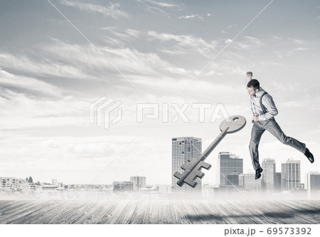 Breaking through access concept with furious man crashing concrete key 69573392