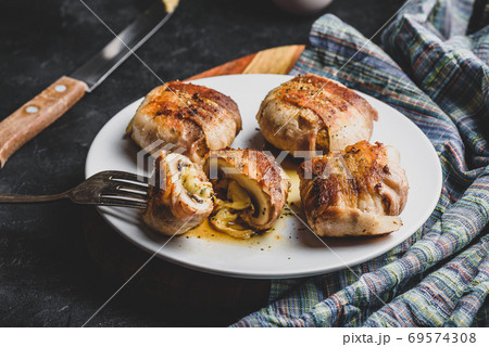 Bacon-wrapped button mushrooms stuffed with cheese Bacon-wrapped button mushrooms stuffed with cheese 69574308