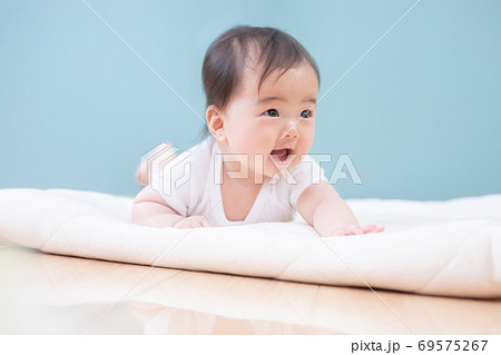 布団にうつぶせになる赤ちゃん 布団にうつぶせになる赤ちゃん 69575267