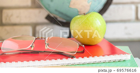 World teachers ' Day in school. Still life with books, globe, Apple, glasses selective focus 69576616