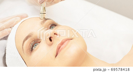 Cosmetology face treatment. Patient young girl. Salon cosmetic hardware. Dermatology diamond skin clean 69578418