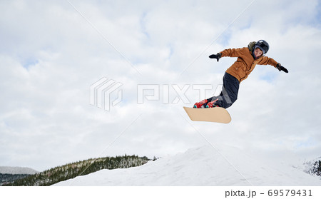 Winter kinds of sport. Skier doing tricks in the mountains in winter season Winter kinds of sport. Skier doing tricks in the mountains in winter season 69579431