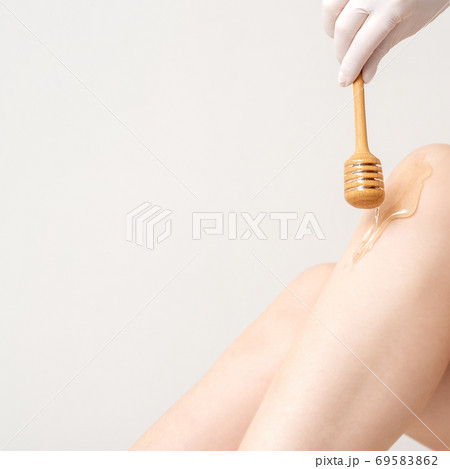 Wax flowing down on female leg 69583862
