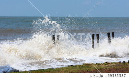 Big waves crushing on shore of a tropical beach island during storm. Stormy sea weather. Power in nature background. Taken before severe cyclone causing flood surge in coastal areas. West Bengal India 69585587