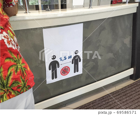 A sign that informs people to keep a social distance. 69586571