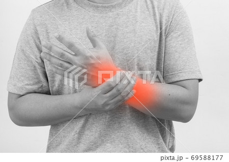 Man wrist pain. Closeup of male arms holding his painful wrist, 69588177