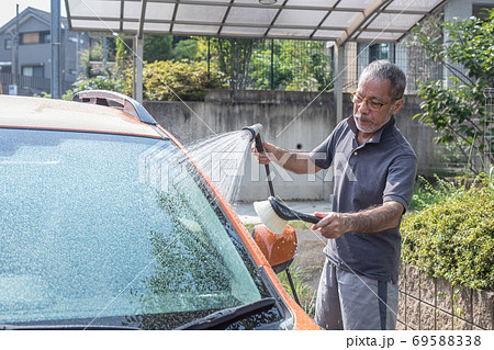 Man Washing His Car With A High Pressure Hose With A Fine Mist Spraying  Stock Photo, Picture and Royalty Free Image. Image 125509581.