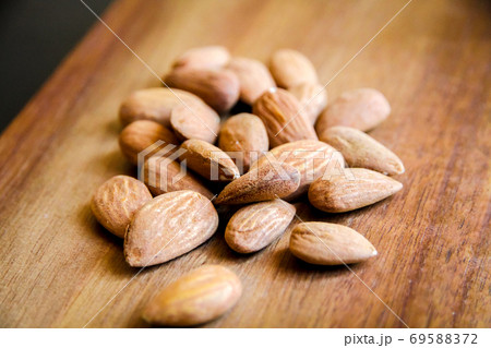 Almonds on a wooden cutting board 69588372