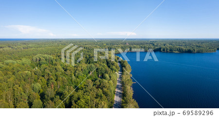 Asphalt freeway through summer forest near lake 69589296