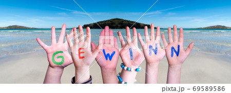 Children Hands Building Word Gewinn Means Prize, Ocean Background 69589586