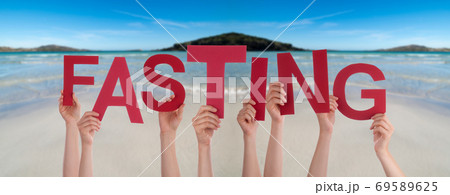 People Hands Holding Word Fasting, Ocean Background People Hands Holding Word Fasting, Ocean Background 69589625