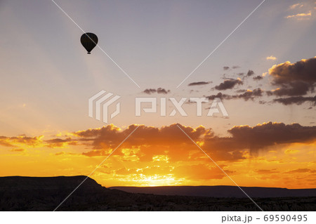 Hot air balloons flying over a volcanic landscape at Cappadocia, Turkey Hot air balloons flying over a volcanic landscape at Cappadocia, Turkey 69590495