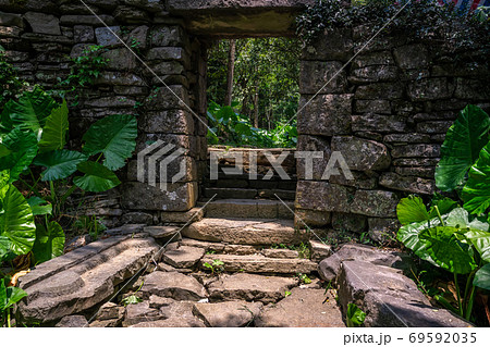 Gate to the ruins of abandoned jungle village in China Gate to the ruins of abandoned jungle village in China 69592035