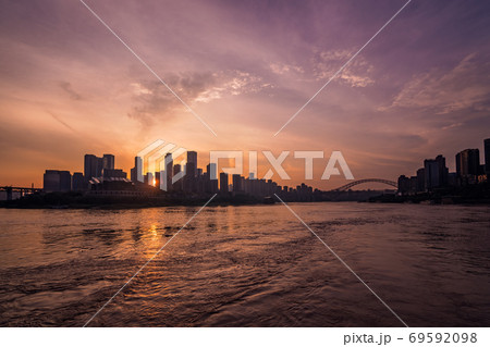 Silhouettes of buildings surrounded by the Yangtze river under the sunlight during the sunset in Chongqing Silhouettes of buildings surrounded by the Yangtze river under the sunlight during the sunset in Chongqing 69592098