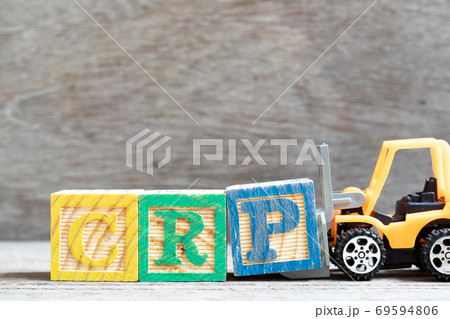Toy forklift hold letter block P to complete word CRP (abbreviation of C-Reactive Protein Test) on wood background 69594806