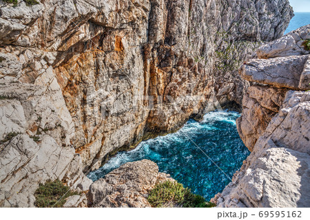 Cliff and blue sea in Capo Caccia 69595162