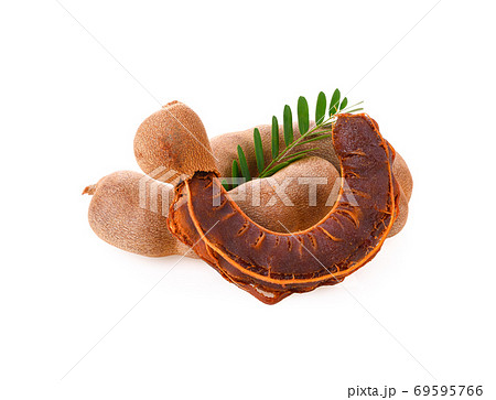 Fresh tamarind fruits with leaves on white background Fresh tamarind fruits with leaves on white background 69595766