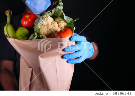 young man with protective mask and gloves delivery goods.  69596243