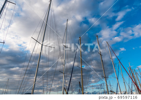 Boats masts under clouds 69597116