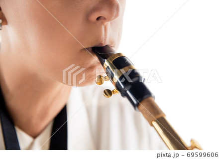 Close up woman playing saxophone isolated on white studio background 69599606