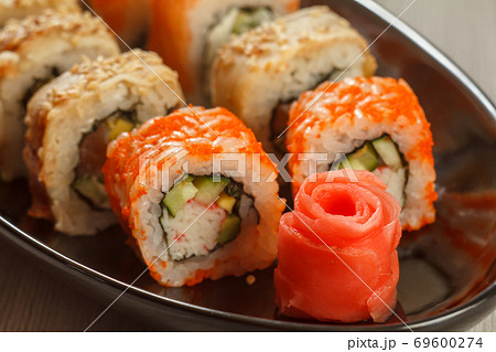 Close up pickled ginger in the form of red rose and sushi rolls Close up pickled ginger in the form of red rose and sushi rolls 69600274
