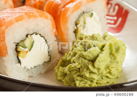 Close up Uramaki Philadelphia. Sushi rolls with salmon, nori, rice and cheese Close up Uramaki Philadelphia. Sushi rolls with salmon, nori, rice and cheese 69600286