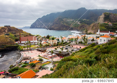 Dramatic coastal scenery of the village of Boaventura and the Arco de Sao Jorge mountain range on the north coast of the Portuguese Island of Madeira Dramatic coastal scenery of the village of Boaventura and the Arco de Sao Jorge mountain range on the north coast of the Portuguese Island of Madeira 69607845
