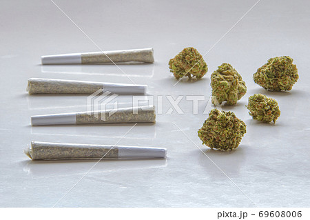Pre-Rolls Cannabis Joints and dried flower marijuana on a clear background Pre-Rolls Cannabis Joints and dried flower marijuana on a clear background 69608006