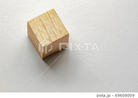 Wood cube with a soft shadow on grey table 69608009
