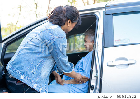 Help and support asian senior woman patient get to her car, healthy strong medical concept. Help and support asian senior woman patient get to her car, healthy strong medical concept. 69611822