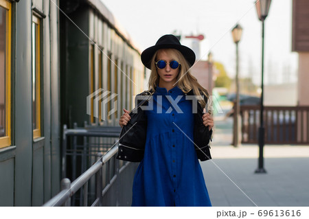 Confident woman standing near train 69613616