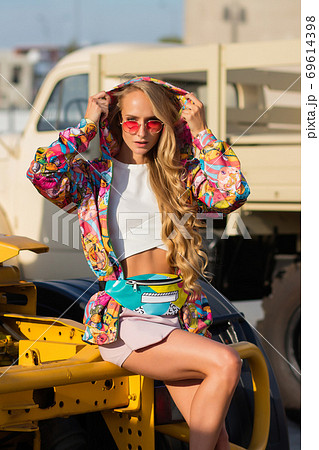 Stylish female sitting on vehicle 69614398