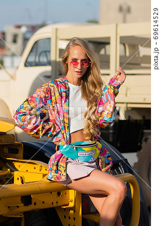 Stylish female sitting on vehicle Stylish female sitting on vehicle 69614529