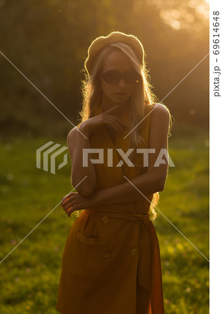 Stylish woman in green park Stylish woman in green park 69614648