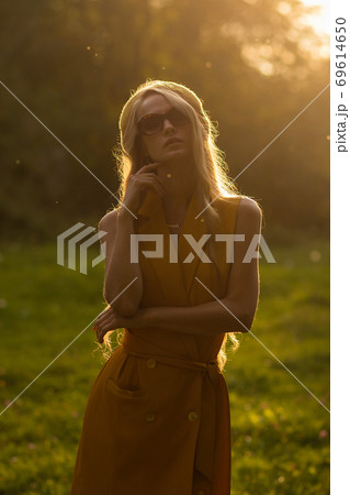 Stylish woman in green park Stylish woman in green park 69614650