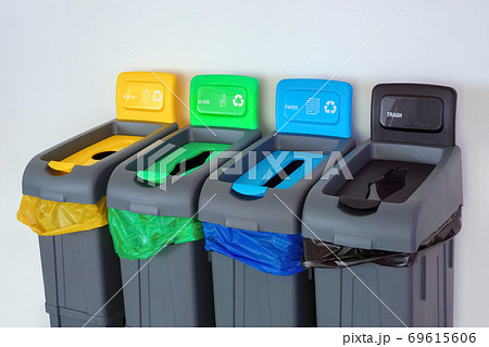 Green,yellow, red,blue color plastic garbage recycle bin in public place. Background of trash paper glass and plastic waste, garbage. Garbage can bin with garbage bags near the wall. Disposal Green,yellow, red,blue color plastic garbage recycle bin in public place. Background of trash paper glass and plastic waste, garbage. Garbage can bin with garbage bags near the wall. Disposal 69615606