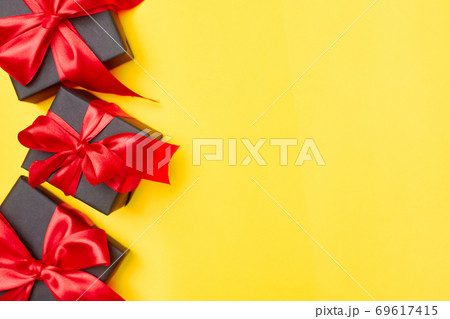Black friday sale flat lay with gift box and ribbon, copy space, christmas and holidays concept on yellow background Black friday sale flat lay with gift box and ribbon, copy space, christmas and holidays concept on yellow background 69617415