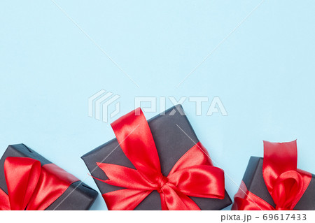 Black friday sale flat lay with gift box and ribbon, copy space, christmas and holidays concept on blue background Black friday sale flat lay with gift box and ribbon, copy space, christmas and holidays concept on blue background 69617433